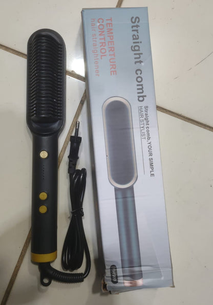 Electric straightening comb with packaging on a tiled floor