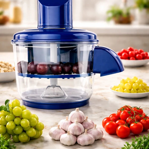 Blue kitchen chopper with fruits and vegetables on a marble countertop